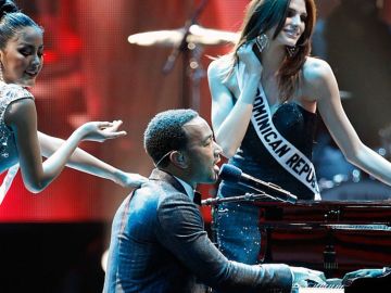 El artista John Legend (C) actúa con Miss República Dominicana 2010, Eva Arias (R), durante el concurso Miss Universo 2010 en el Mandalay Bay Events Center el 23 de agosto de 2010 en Las Vegas, Nevada.