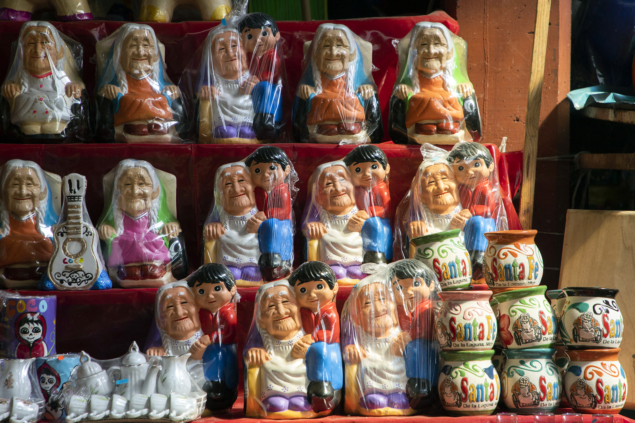 Merchandise of the Disney Pixar film Coco is pictured in Santa Fe de la Laguna, Michoacan state, Mexico, on October 30, 2022. - Relatives of Maria Salud Ramirez Caballero, who died on October 18, 2022, claim that the character of Mama Coco from de Disney Pixar movie was inspired by her. The sweet old lady who gave her name to "Coco", winner of the 2017 Oscar for best animated film, was a fictional character created with the famed US studio's sophisticated technology. (Photo by ENRIQUE CASTRO / AFP) (Photo by ENRIQUE CASTRO/AFP via Getty Images)